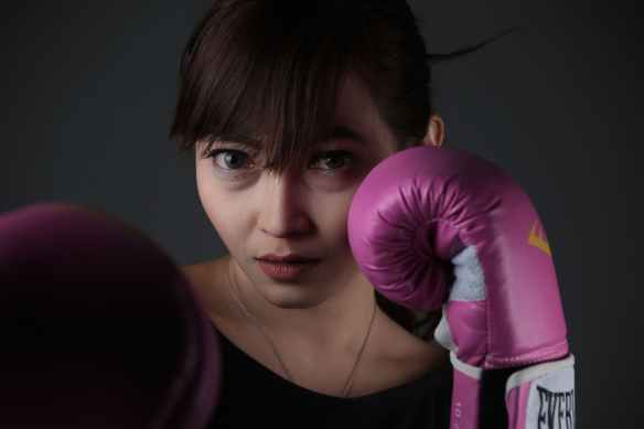 woman wearing purple boxing gloves